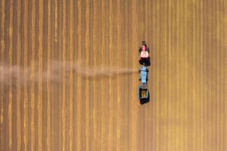 Almond picker harvester processing a field, Aerial view.の写真素材