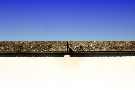 Rocks line between a wall and the skyの写真素材