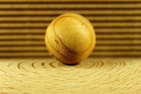 Wood ball on a brown backgroundの写真素材