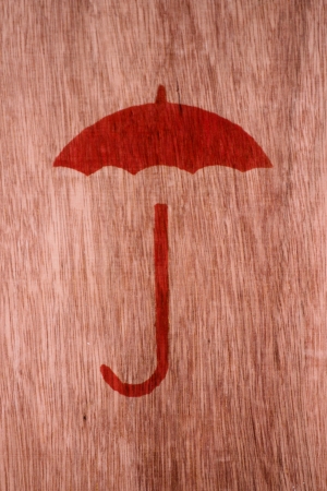 Red umbrella drawn on woodの写真素材