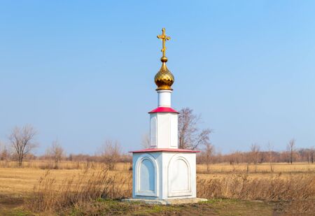 Orthodox Golden cross of worship stands alone in the fieldの写真素材