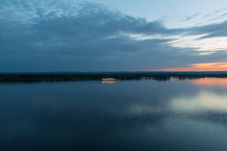 Panorama a white three deck ship lit by lights on the morning river.の写真素材