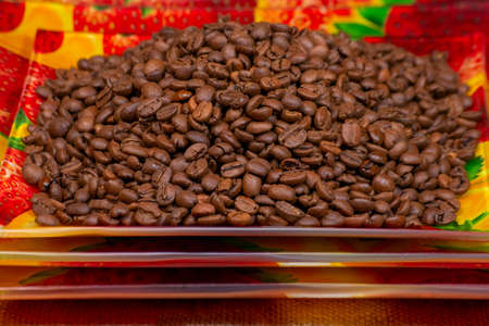 Coffee beans roasted on a ceramic rectangular plate