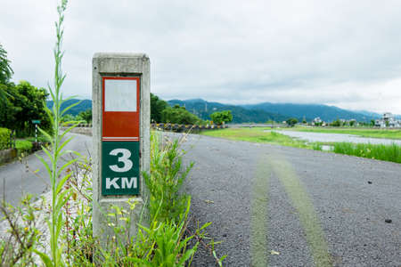 Kilometer sign on the bicycle lane by the riverの写真素材