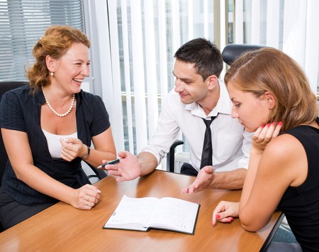 Manager with office workers on meeting in board roomの写真素材