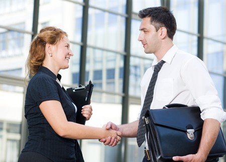 Handshake between office workers outdoorの写真素材