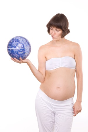 Pregnant woman in studio take look on globe of Spaceの写真素材