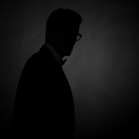 silhouette of man in a tuxedo on greyの写真素材