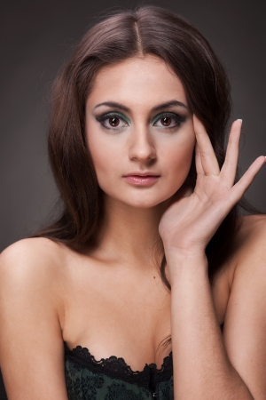 Beautiful brunette woman on grey backgroundの写真素材