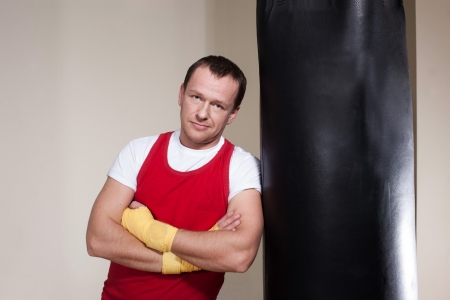 Man in yellow boxing gloves makes a series of exercisesの写真素材