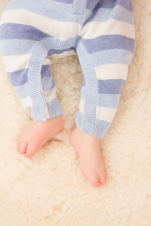 Close up of infant baby feel on fur