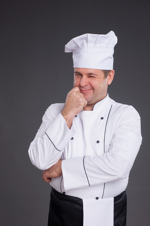 Portrait of chief cook with hand sign on grey backgroundの写真素材
