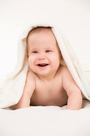 Infant baby in towel on white backgroundの写真素材