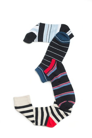 Number three made from dark and light colours of socks. Short socks put on white background.の写真素材