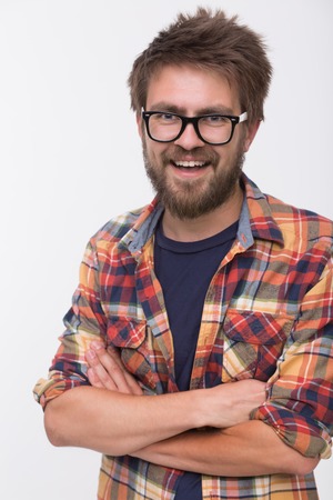 Portrait of bearded man in glasses on white background. Man in T-shirt and shirt smiling with his...