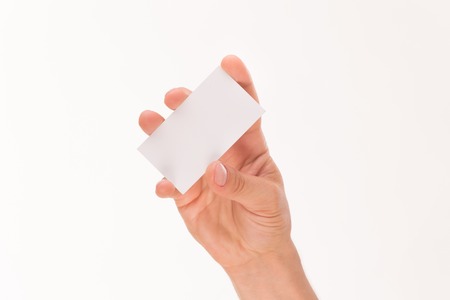 Blank card in man's hand isolated on white background. Man trying to demonstrate a credit card with his right hand.の写真素材