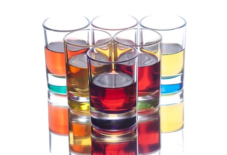 Colorful alcohol drinks in set from 6 glasses on white backgroundの写真素材