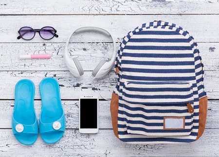 Summer holidays memories from beach with bag, earphones, flip flops, sunglasses and lip gloss. All...