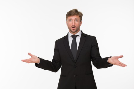 Picture of surprised businessman at a loss. Handsome man posing with amazement isolated on white background.の写真素材