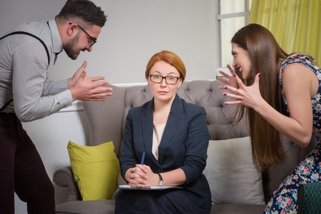 Horizontal view of psychotherapist listening to the problems of young couple during psychotherapy.