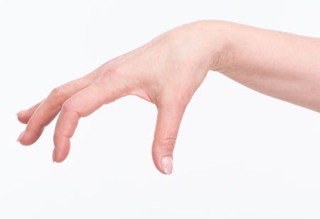 Elegant old woman's hand with perfect manicure isolated over white background. Old woman holding something in the air.の写真素材
