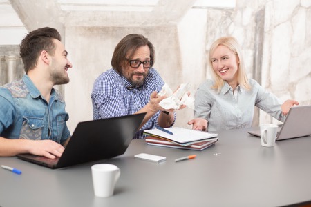 Business man and woman smiling and explaining their colleague that everything in fine and okay....