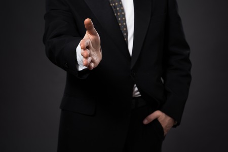Businessman offering his hand for handshake. Greeting or congratulating gesture. Business meeting and success.の写真素材