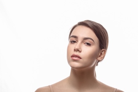 Closeup portrait of shirtless lady posing over white background. Young woman demonstrating her...