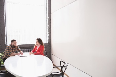 Picture of business meeting of man and woman in office. Man and woman communicating about business...
