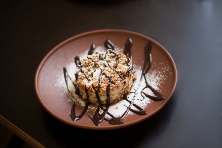 Picture of vegan dish represented on wooden plate. Sweet meal is being served in vegan restaurant or cafeの写真素材