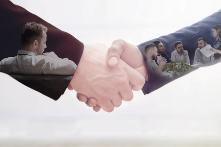 Handshake of two business man on white. Double exposure concept of business team work.の写真素材