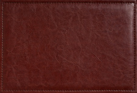 Brown leather texture closeup may be used for any background. Blank natural leather label jeans tag...