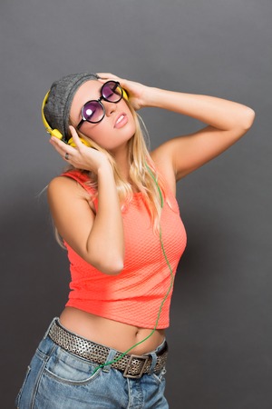 Close-up portrait of a girl in earphones enjoying modern music.の写真素材