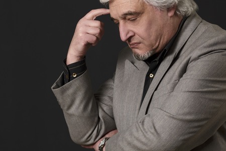 Portrait of professor man of university or college thinking about theories and concepts in studio.