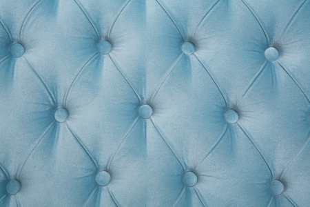 Picture of sofa texture background. Closeup picture of dark blue leather texture background with buttoned pattern.の写真素材