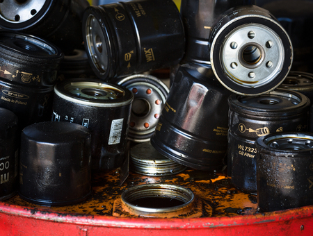 Closeup picture of old oil filters for automobile. Picture of motor oil as product of oil refining...