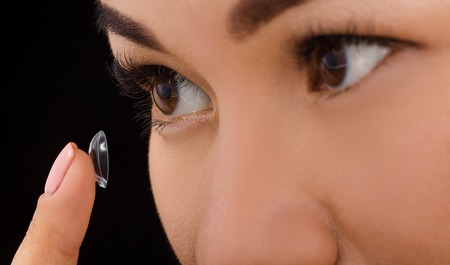 Beauty, vision, eyesight, ophthalmology and people concepts. Closeup of Korean woman putting on...