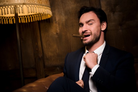 Rich businessman with cigarの写真素材