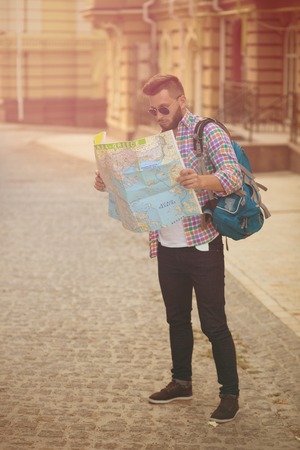 Young hipster man with map