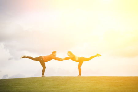 Sport man and woman training in parkの写真素材