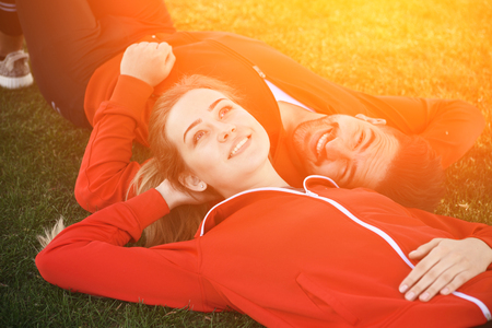 Sport man and woman resting in parkの写真素材