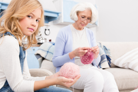 Grandmother and granddaughter knittingの写真素材