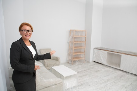 Realtor in living room proposing to view an apartment.の写真素材