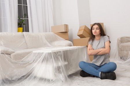 Brunette young woman trying to be patient while relocating to new apartment.の写真素材