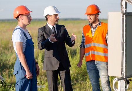 Businessman explaining working process of solar panels to employees.
