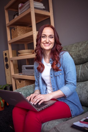 Happy foxy woman working on freelance.