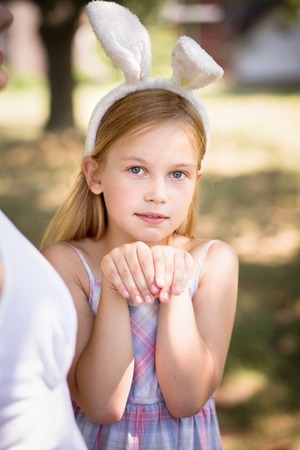 Little girl with bunny ears posing for photo.の写真素材
