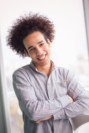 Portrait of young businessman in shirt with crossed arms.の写真素材