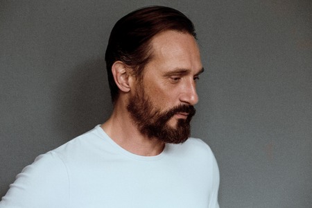 Man actor on grey background with severe face.の写真素材