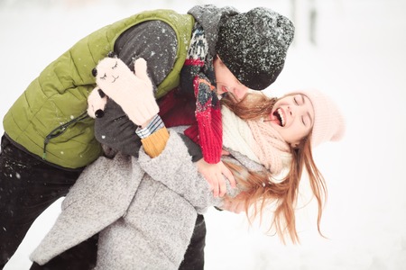 Like in childhood. Snow is everywhere, but smiling girl does not want to fall into snow.